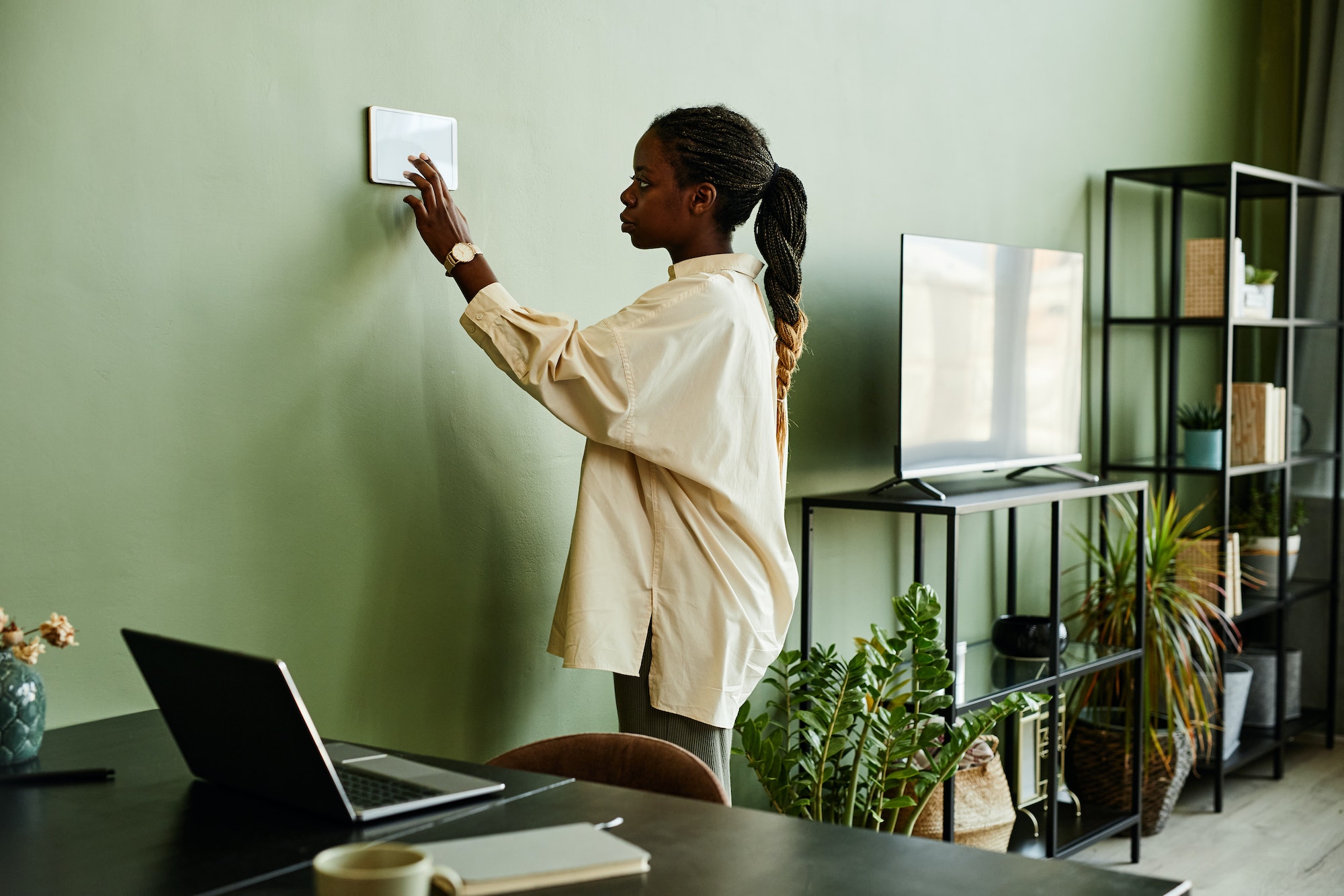 African American Woman Operating Smart Home System